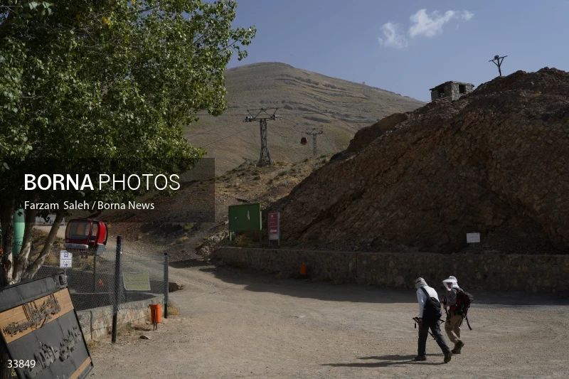 Climbing Tochal Peak with the flag of Imam Hossein (AS)