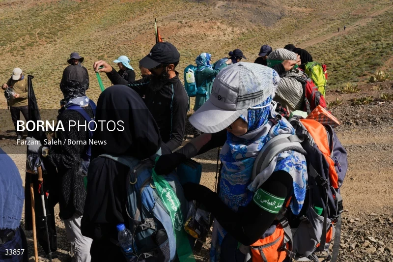 Climbing Tochal Peak with the flag of Imam Hossein (AS)