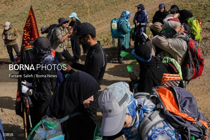 Climbing Tochal Peak with the flag of Imam Hossein (AS)