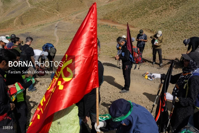 Climbing Tochal Peak with the flag of Imam Hossein (AS)