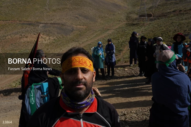 Climbing Tochal Peak with the flag of Imam Hossein (AS)